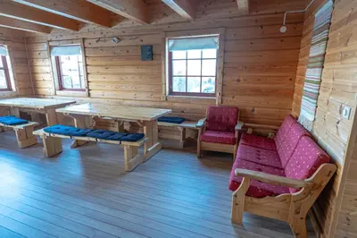 a log cabin with tables and chairs and windows at Active Adventure Base - Apartment & Lavvo, Dagali Fjellpark in Dagali