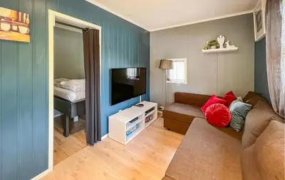 a living room with a couch and a flat screen tv at 1 Bedroom Amazing Apartment In Øyer in Øyer