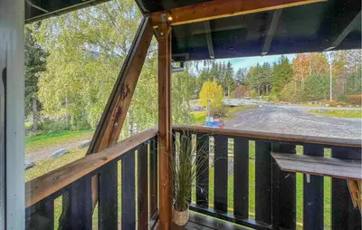 a porch with a bench and a view of a street at 1 Bedroom Amazing Apartment In Øyer in Øyer