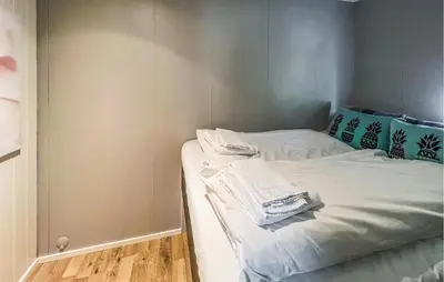 a bed with white sheets and towels on it at 1 Bedroom Amazing Apartment In Øyer in Øyer