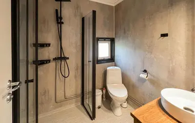 a bathroom with a shower and a toilet and a sink at 1 Bedroom Amazing Apartment In Øyer in Øyer
