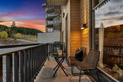 a balcony with two chairs and a table on a building at New Nice apartment Trysil alpine lodge with the lift right outside in Trysil