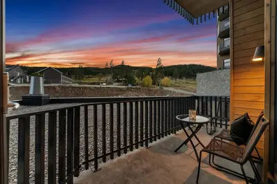 a balcony with a view of a sunset at New Nice apartment Trysil alpine lodge with the lift right outside in Trysil