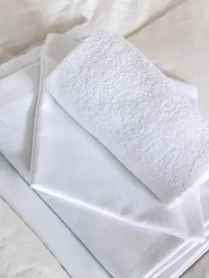a white napkin sitting on top of a bed at Trolltunga Hostel in Tysso