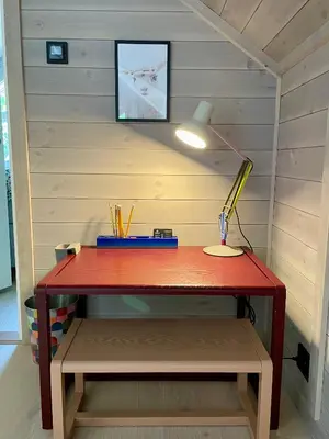 a red desk with a lamp on it in a room at Villa Blue Dream in Kristiansund