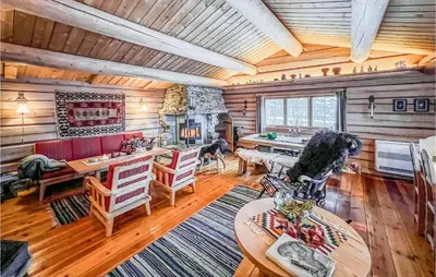 a living room with a table and chairs in a cabin at Stunning Home In Kvam With Wifi in Kvam