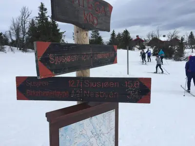 a sign for a ski resort with people skiing in the snow at Hytte i Ringsaker (Ljøsheim/Sjusjøen) in Ringsaker