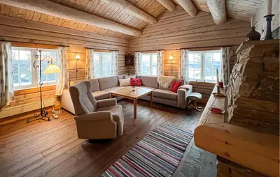 a living room with a couch and a table at 3 Bedroom Gorgeous Home In Sjusjøen in Sjusjøen