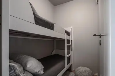 a bedroom with two bunk beds in a room at Høyfjellsgrend 962 in Trysil