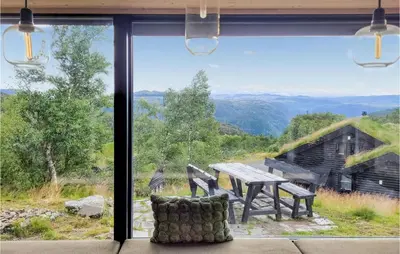 a window with a picnic table and a view of the mountains at Beautiful Home In Jøsenfjorden in Gullingen