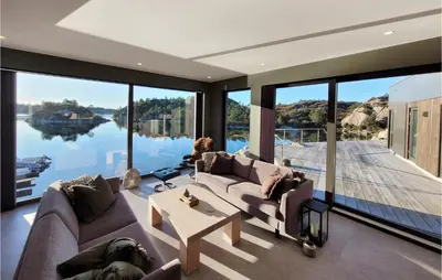 a living room with a large view of a lake at 5 Bedroom Lovely Home In Urangsvåg in Ervik
