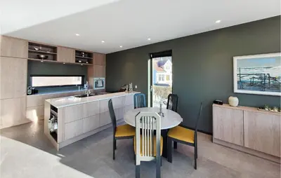 a kitchen with a table and a sink at 5 Bedroom Lovely Home In Urangsvåg in Ervik