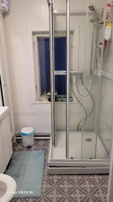a shower with a glass door in a bathroom at Comfortable zone in Hønefoss