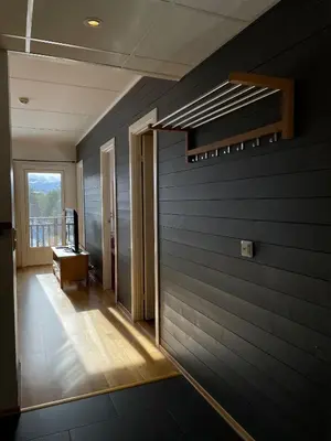 a room with a blue wall with a window at Hovdestøylen Apartments in Hovden