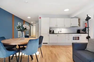a kitchen and dining room with a table and chairs at Flåmsbrygga Apartments in Flåm