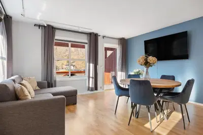 a living room with a table and a couch at Flåmsbrygga Apartments in Flåm
