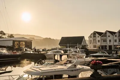 a group of boats are docked in a marina at Bekkjarvik Gjestgiveri in Bekkjarvik
