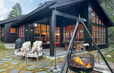 a house with a fireplace in front of it at Stunning Home In Rjukan With Wifi in Rjukan