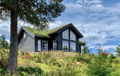 a house with a grass roof on a hill at Awesome Home In Kvam With Sauna in Kvam