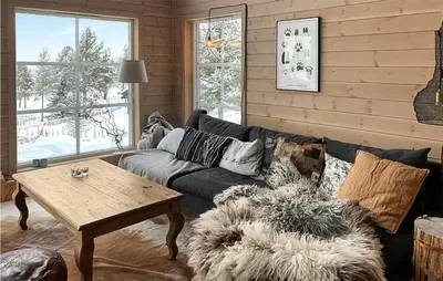 a living room with a couch and a table at Awesome Home In Kvam With Sauna in Kvam