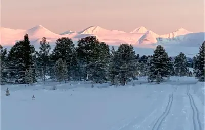 a snowy mountain range with trees and snow covered mountains at Awesome Home In Kvam With Sauna in Kvam