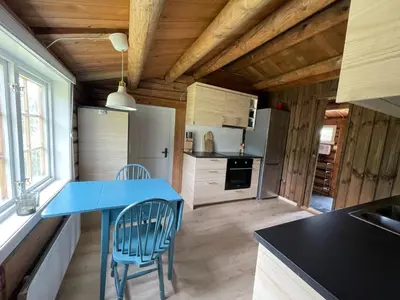 a kitchen with a blue table and two chairs at Maurtua - cabin in lovely surroundings in Kvam