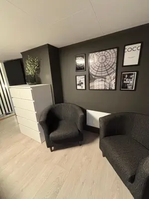 a waiting room with two chairs and a dresser at Private house in Orkanger, 35 minutes from Trondheim in Orkanger