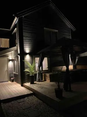 a house with an umbrella in front of it at night at Private house in Orkanger, 35 minutes from Trondheim in Orkanger