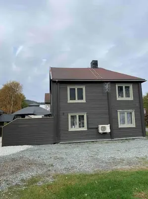 a brown house with a red roof at Private house in Orkanger, 35 minutes from Trondheim in Orkanger
