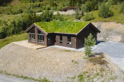 a small house with a grass roof on a hill at Chill cabin - fantastic view and nice hiking area in Aurdal