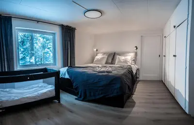 a bedroom with a bed and a window at Mountain & Lake Haven & Close to Oslo in Stange