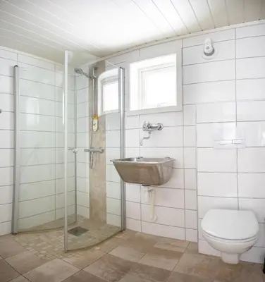 a bathroom with a toilet and a sink at Mountain & Lake Haven & Close to Oslo in Stange