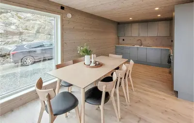 a kitchen and dining room with a table and chairs at 4 Bedroom Amazing Home In Skånevik in Skånevik