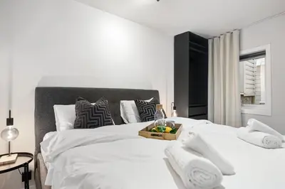 a bedroom with a white bed with a basket of fruit on it at King bed - Behind Bryggen - Renovated des 23 in Bergen