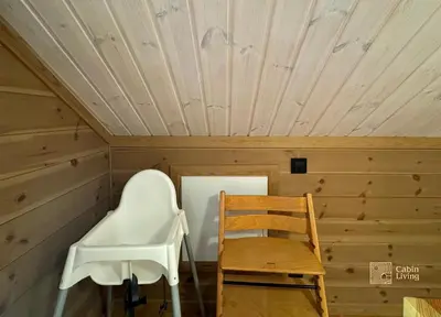 a wooden room with a chair and a table at Cozy cabin on Sjusjølia by the trail network sauna in Ringsaker