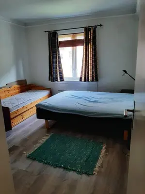 a bedroom with a bed and a window and a rug at Apartment 2 sleeping rooms in Rjukan in Rjukan