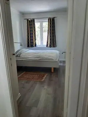 a small bedroom with a bed and a window at Apartment 2 sleeping rooms in Rjukan in Rjukan