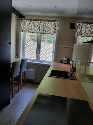 a kitchen with a large window and a kitchen counter at Apartment 2 sleeping rooms in Rjukan in Rjukan