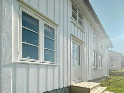 a white building with windows on the side of it at 7 person holiday home in Averøy-By Traum in Averoy
