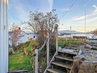 a set of stairs leading up to a house at 7 person holiday home in Averøy-By Traum in Averoy