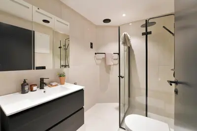 a bathroom with a sink and a shower at West Coast Apartments Aalesund in Ålesund