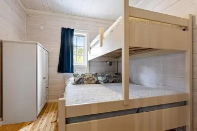 a bedroom with a bunk bed and a staircase at Koslig hytte ved Grimsdalen in Dovre