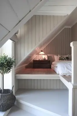 a bedroom with a staircase with a bed in it at Petrines Gjestgiveri in Norddal
