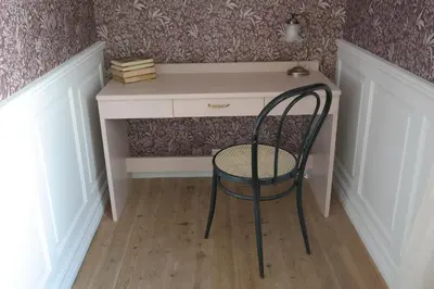 a chair sitting in front of a desk at Petrines Gjestgiveri in Norddal