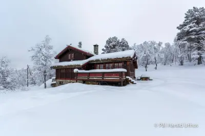 a house with snow on top of it at Large cabin with spectacular views in Geilo in Geilo
