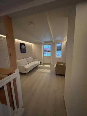 a living room with a couch and a table at Handelsmannens hus ved Otnesbrygga, Valsøyfjord in Otnes