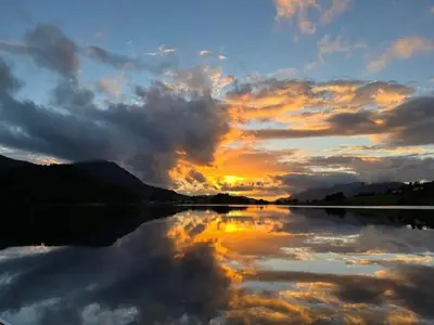 a reflection of a sunset in a lake at Hus ved Valsøyfjorden in Otnes