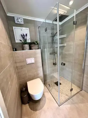 a bathroom with a toilet and a glass shower at Hus ved Valsøyfjorden in Otnes