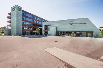 a large parking lot in front of a building at Quality Hotel Ulstein in Ulsteinvik