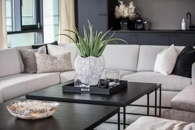 a living room with a couch and a coffee table at Quality Hotel Ulstein in Ulsteinvik